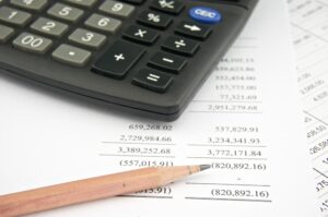 Statements of income include sales with pencil and black calculator.