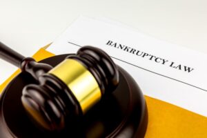 Judges gavel on document of prosecution in brown envelope regarding Bankruptcy Law